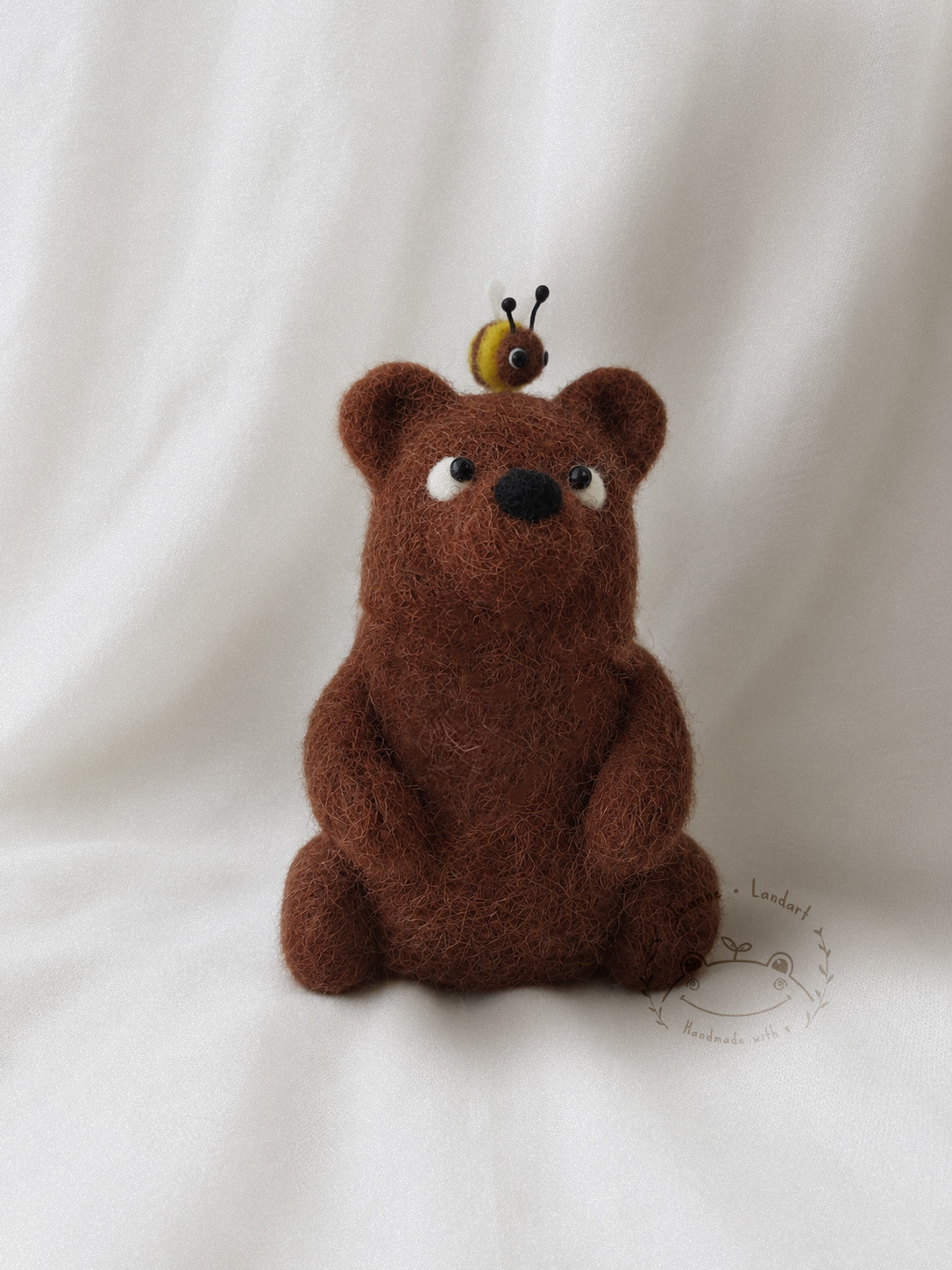 Felted figurine of a bear and its bee